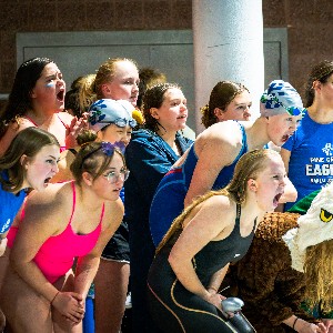 Swimmers cheering on their team mates